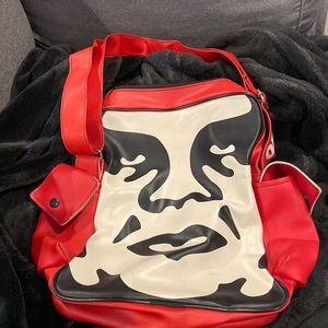 Red , black and white OBEY bag .